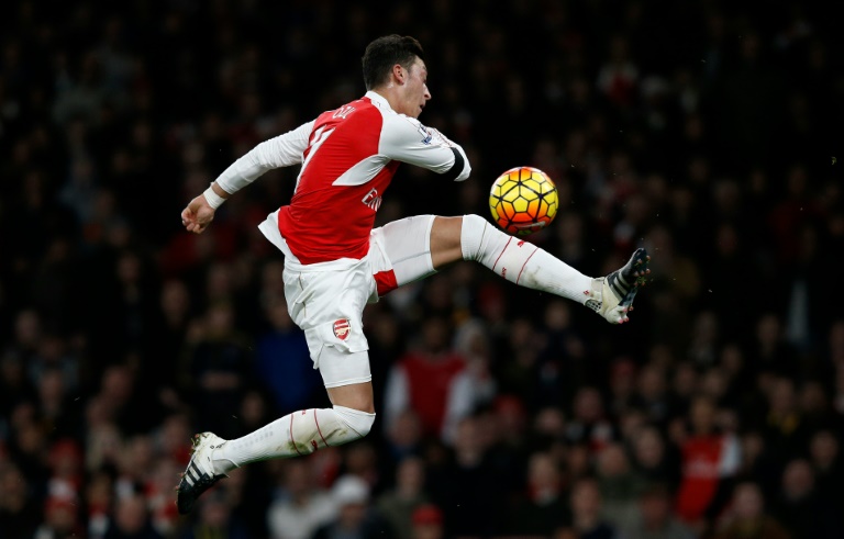 Inspired Ozil fires Arsenal to top spot